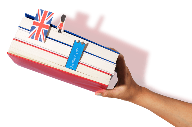 A hand holding a stack of English-language books