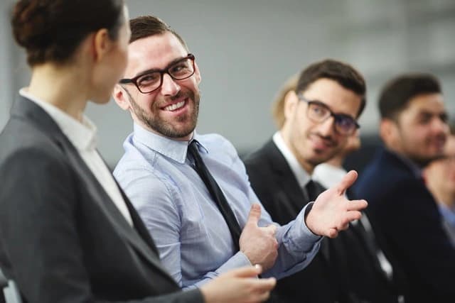 Three colleagues reviewing documents together in an office